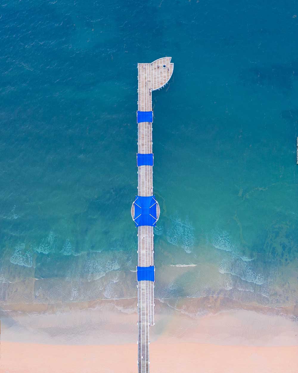 Aerial view of the Pompano Beach pier extending over the Atlantic Ocean